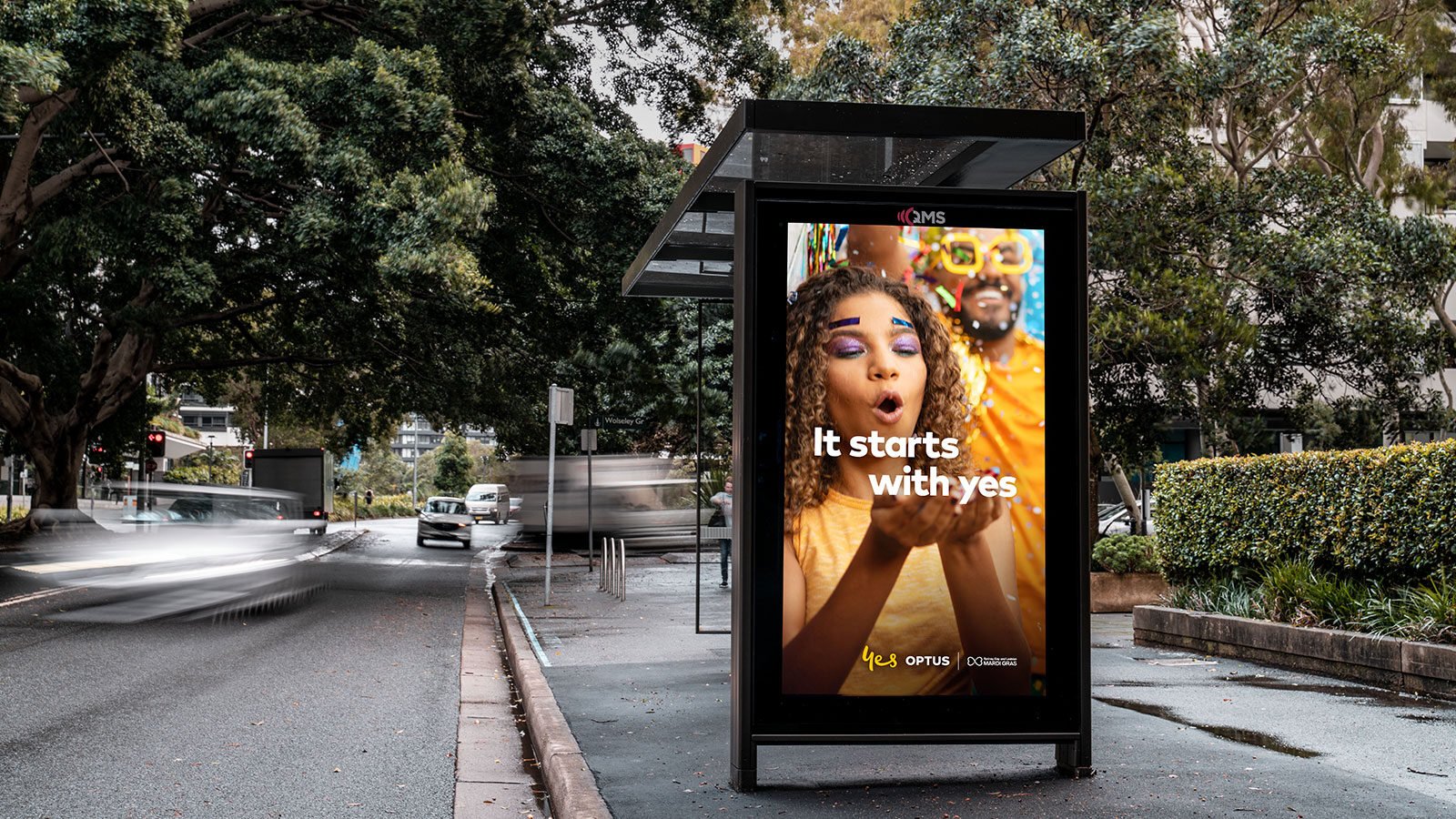 OOH billboard alongside digital advertising screens in a city